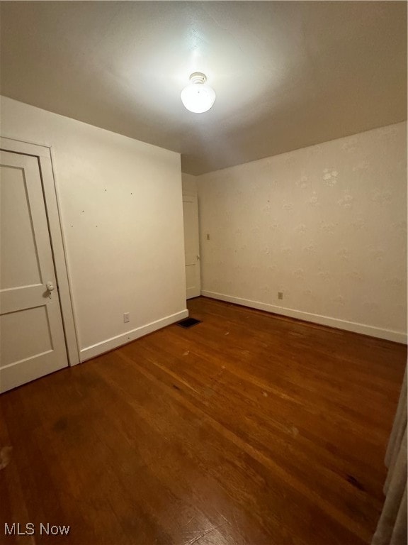 unfurnished room featuring dark hardwood / wood-style floors