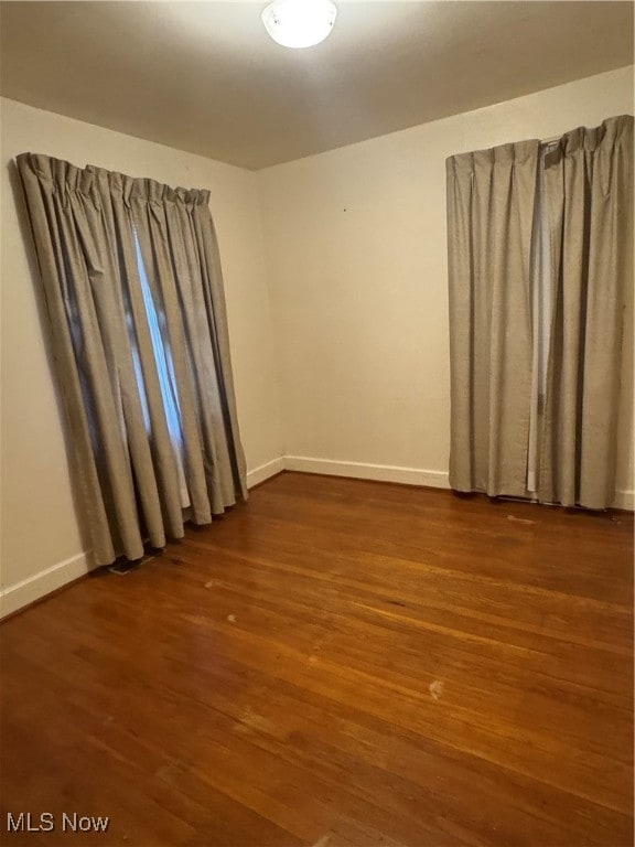 empty room featuring dark wood-type flooring