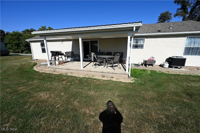 rear view of house featuring a yard, a patio area, and central air condition unit