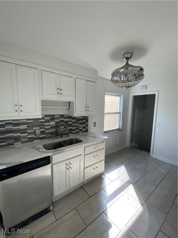 kitchen with white cabinetry, dishwasher, sink, decorative backsplash, and light tile patterned floors