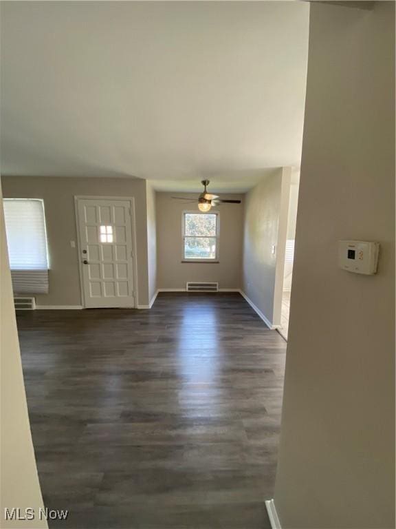 foyer with ceiling fan and dark hardwood / wood-style flooring