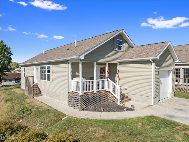 view of front of home with a front yard, a garage, and covered porch