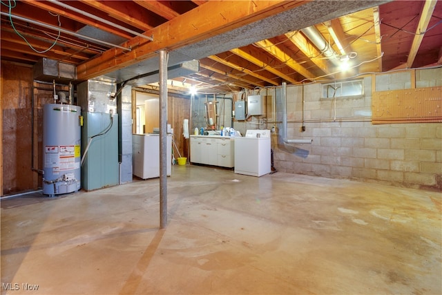 basement with gas water heater, electric panel, and independent washer and dryer