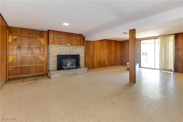 1701 New England Ridge Rd, Washington, WV 26181 - unfurnished living room with wooden walls, a fireplace, and light floors