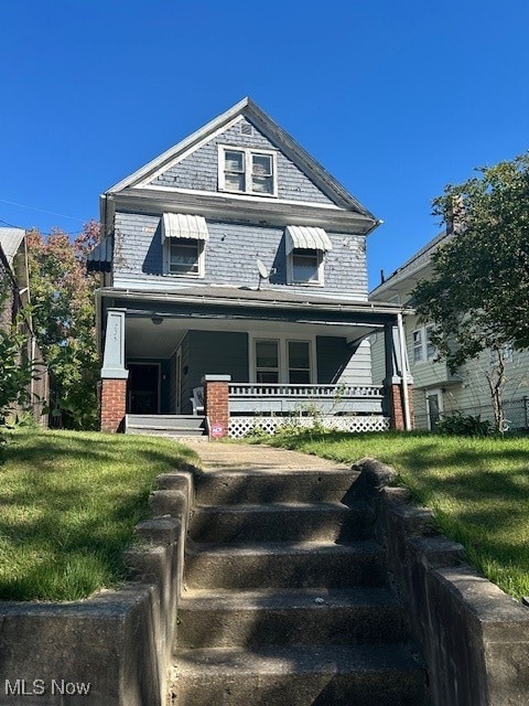 view of front facade with a front yard and a porch