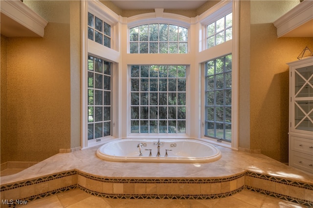 bathroom with tile patterned flooring and a relaxing tiled tub