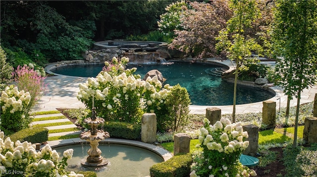 view of pool with pool water feature and an in ground hot tub