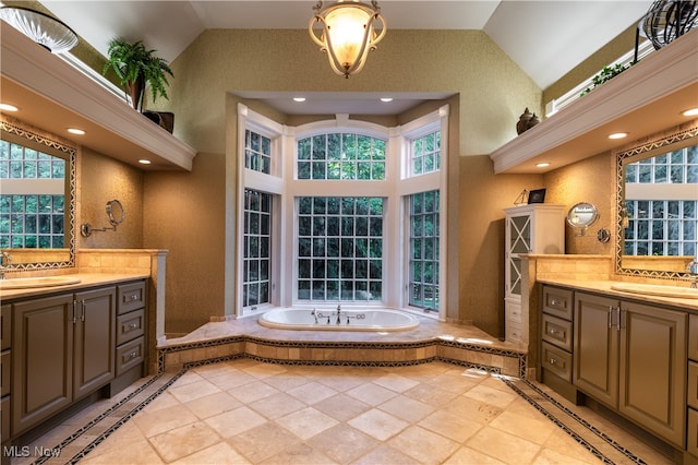 bathroom featuring a tub to relax in, vanity, and high vaulted ceiling