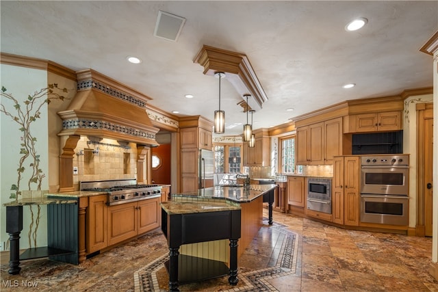 kitchen with light stone counters, hanging light fixtures, built in appliances, a center island, and decorative backsplash