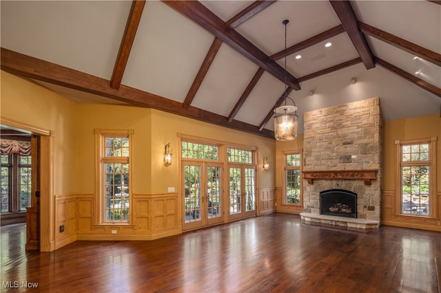 unfurnished living room featuring high vaulted ceiling, beamed ceiling, dark hardwood / wood-style floors, and a fireplace