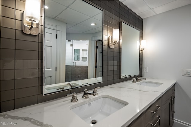 bathroom featuring walk in shower and vanity