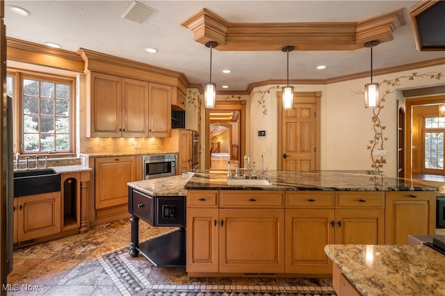 kitchen featuring pendant lighting, a center island, crown molding, and sink