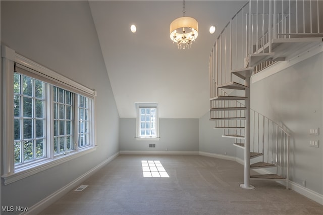 interior space with carpet, vaulted ceiling, and a chandelier