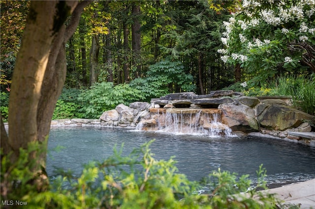 view of pool featuring a water view