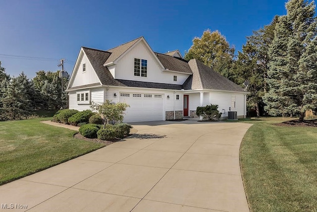 view of front of house with a front yard, a garage, and central air condition unit