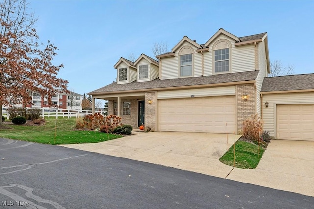 view of front of property with a front yard and a garage