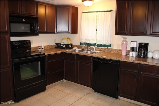 kitchen featuring black appliances, sink, and light tile patterned floors