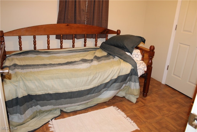 bedroom with parquet flooring