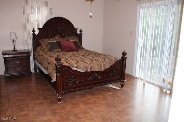 bedroom with access to outside and dark parquet floors