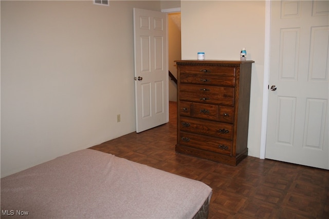 bedroom with dark parquet floors