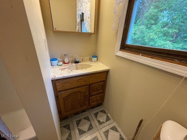 bathroom featuring vanity and toilet