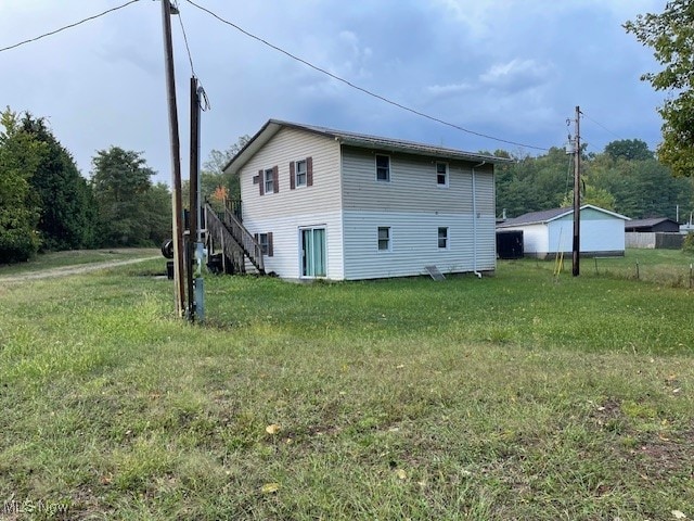 view of side of property with a lawn