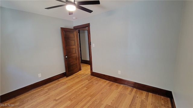 spare room featuring light hardwood / wood-style floors and ceiling fan