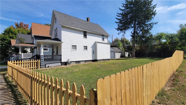 back of house with a porch and a yard