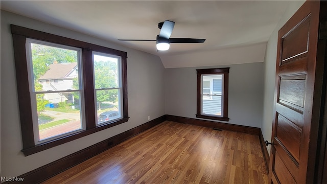 empty room featuring light hardwood / wood-style floors, ceiling fan, and vaulted ceiling