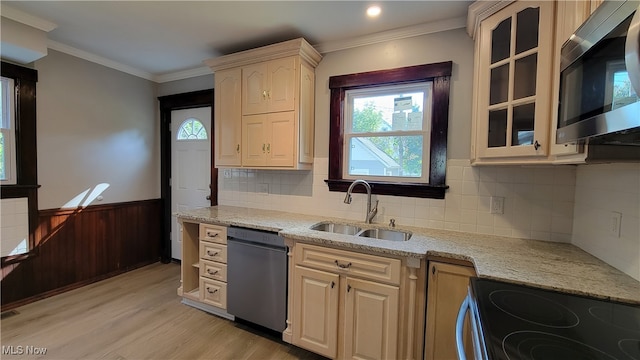 kitchen with light stone counters, sink, appliances with stainless steel finishes, crown molding, and light hardwood / wood-style floors