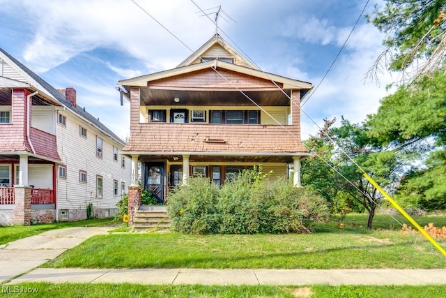 view of front of house with a porch and a front yard