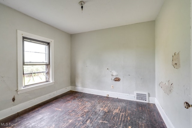 empty room with dark wood-type flooring