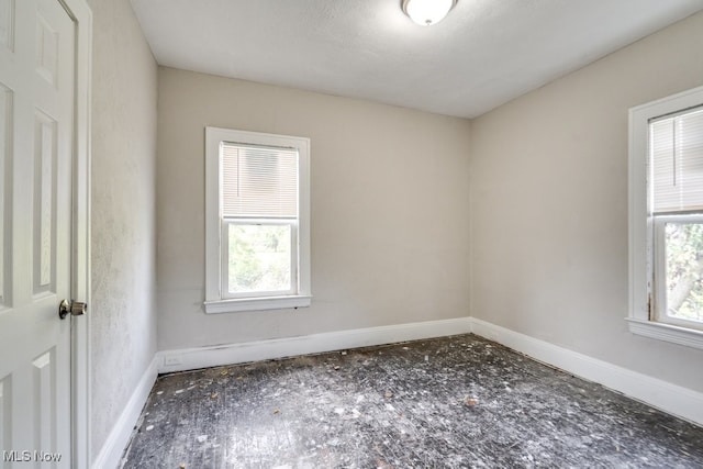 unfurnished room featuring a textured ceiling