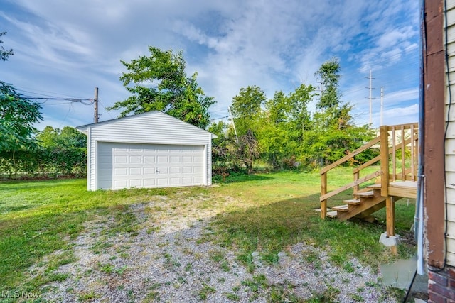 view of yard featuring an outdoor structure and a garage