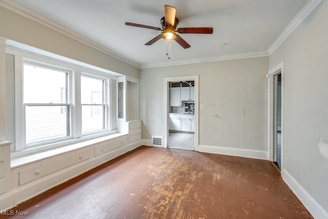 unfurnished bedroom with ensuite bath, ceiling fan, dark wood-type flooring, and crown molding