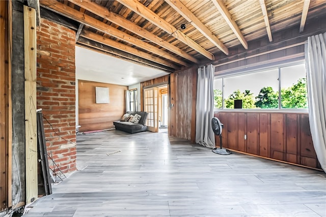 misc room featuring wooden walls, beam ceiling, wooden ceiling, and light wood-type flooring