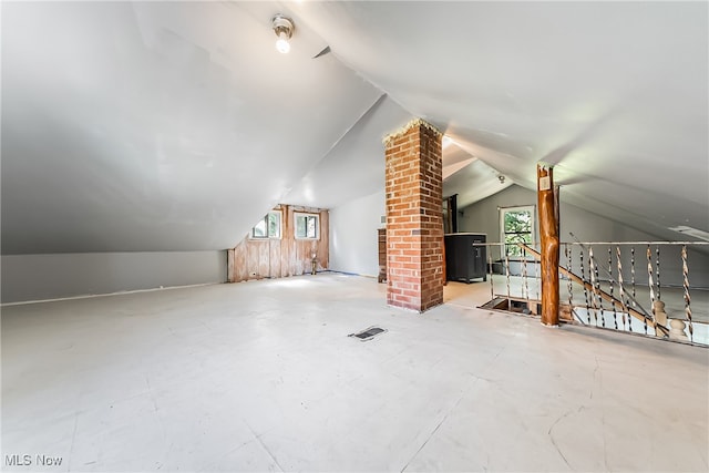 additional living space with a wealth of natural light, vaulted ceiling, and ornate columns