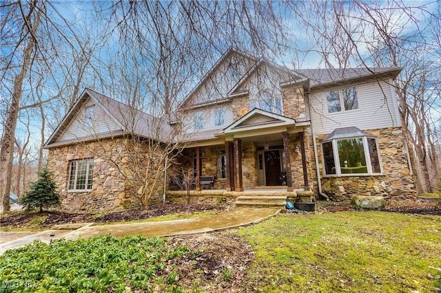 view of front of property featuring covered porch and a front yard