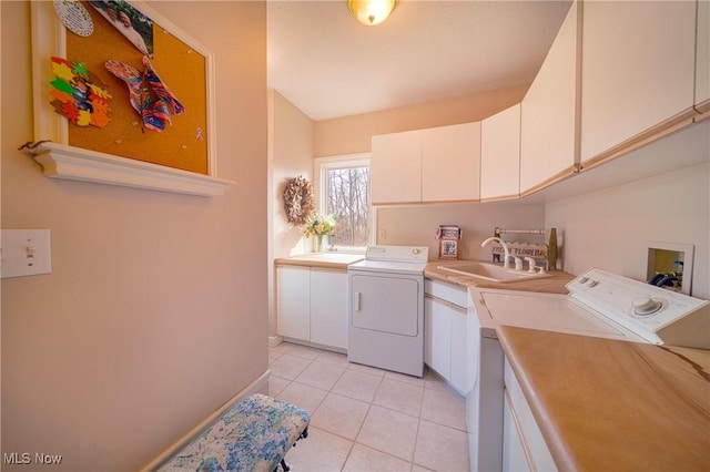 10000 Wisner Rd, Chardon, OH 44024 - clothes washing area with separate washer and dryer, baseboards, light tile patterned floors, cabinet space, and a sink