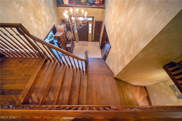 10000 Wisner Rd, Chardon, OH 44024 - stairs featuring a chandelier, a towering ceiling, and a textured wall