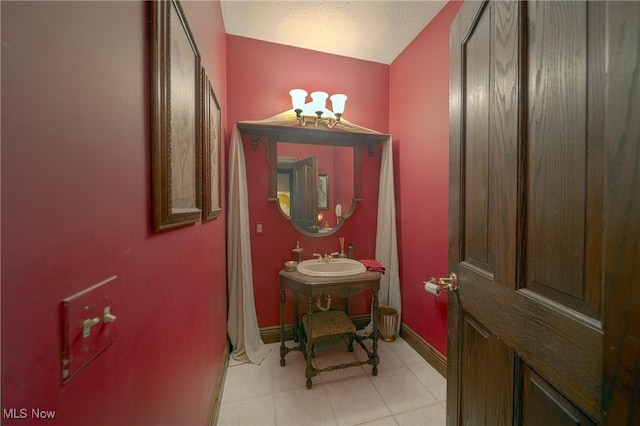 bathroom featuring a textured ceiling and sink