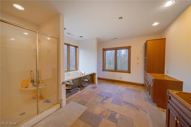 bathroom featuring plus walk in shower and vanity