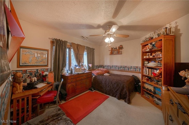 10000 Wisner Rd, Chardon, OH 44024 - carpeted bedroom featuring visible vents, a textured ceiling, a ceiling fan, and a wainscoted wall