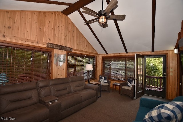 carpeted living room with ceiling fan, wooden walls, beam ceiling, and high vaulted ceiling