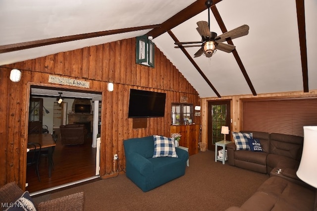 living room featuring ceiling fan, hardwood / wood-style flooring, wooden walls, and lofted ceiling with beams