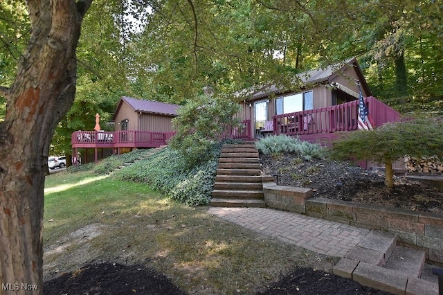 rear view of property featuring a wooden deck