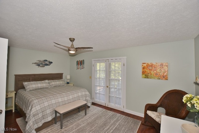 bedroom featuring a textured ceiling, access to outside, ceiling fan, and dark wood-type flooring