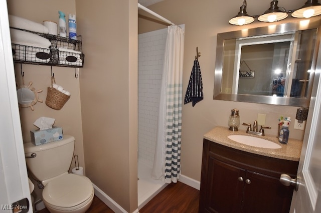 bathroom featuring walk in shower, hardwood / wood-style floors, vanity, and toilet