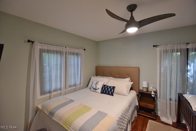 bedroom featuring ceiling fan and dark hardwood / wood-style flooring