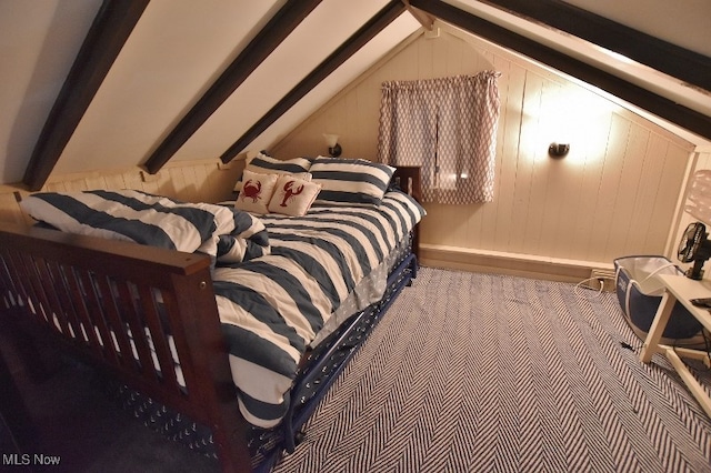 bedroom with carpet flooring, lofted ceiling with beams, and wood walls